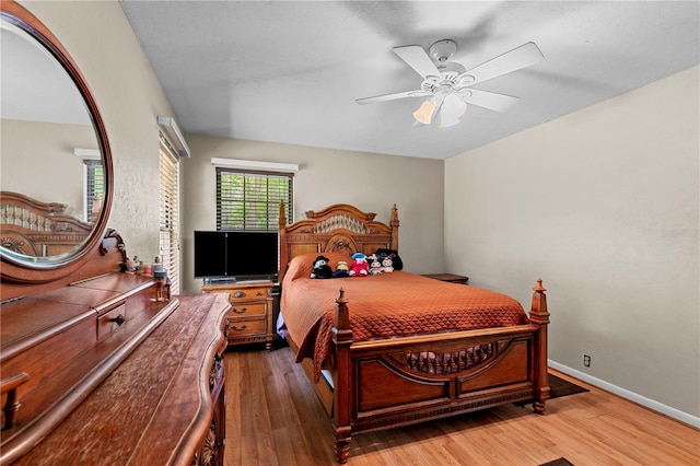 bedroom with ceiling fan and dark wood-type flooring