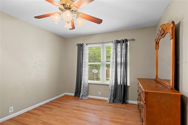 unfurnished room with ceiling fan and light hardwood / wood-style flooring