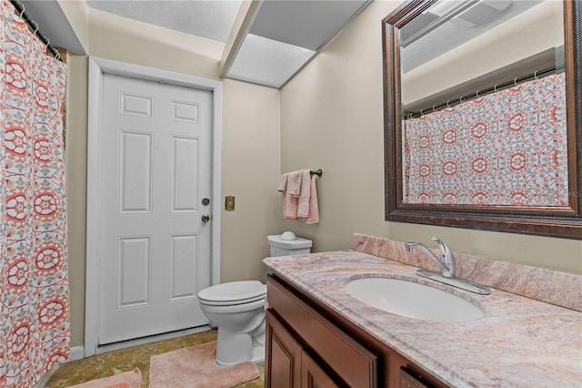 bathroom featuring tile flooring, oversized vanity, and toilet