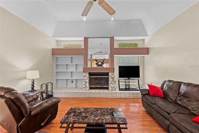 living room featuring high vaulted ceiling, ceiling fan, light wood-type flooring, and plenty of natural light