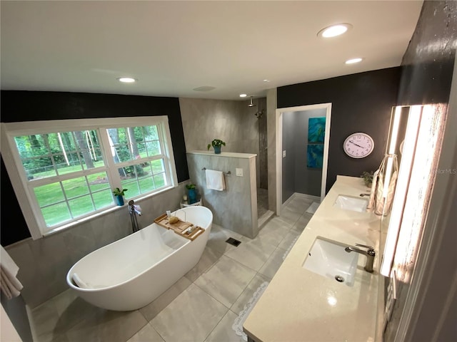 bathroom featuring separate shower and tub, vanity, and tile patterned flooring