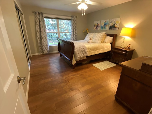 bedroom featuring dark wood-type flooring, ceiling fan, and a closet