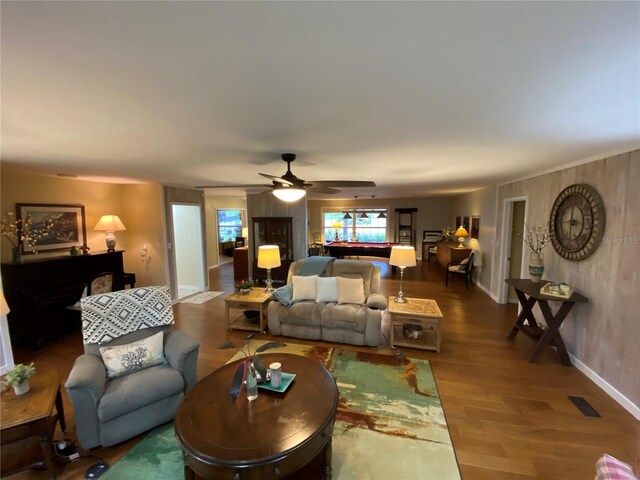 living room featuring ceiling fan and wood-type flooring