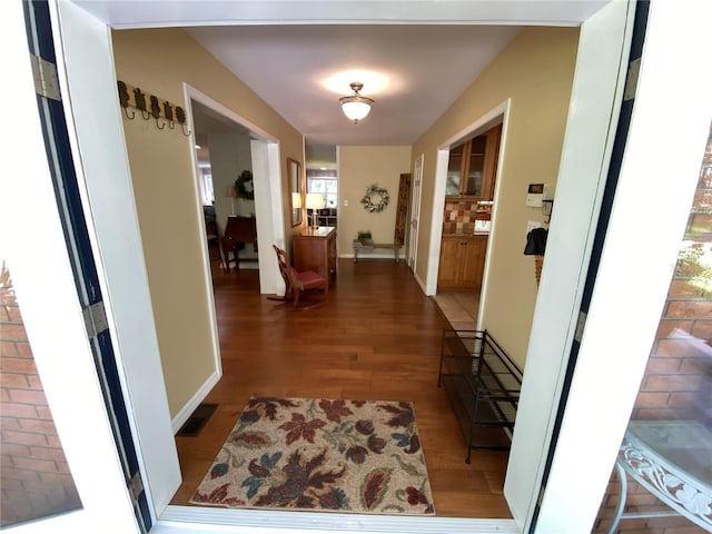 hallway with hardwood / wood-style floors