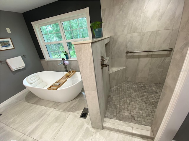 bathroom with tile patterned flooring and plus walk in shower