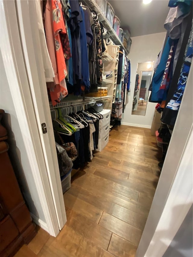 spacious closet featuring light hardwood / wood-style floors