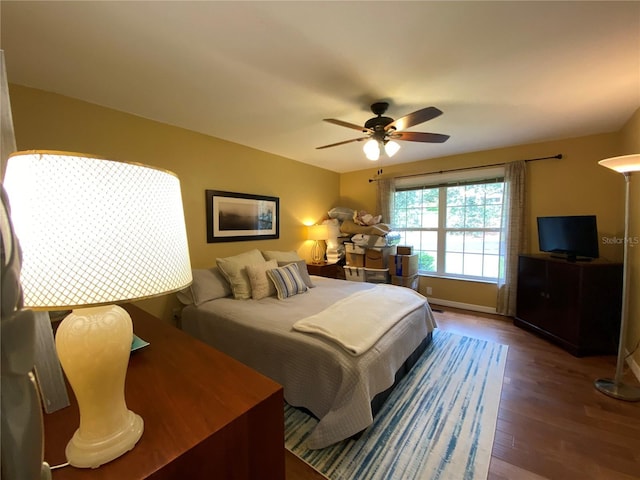 bedroom with ceiling fan and hardwood / wood-style floors