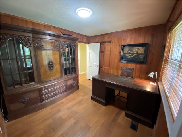 office area featuring wood-type flooring and wooden walls