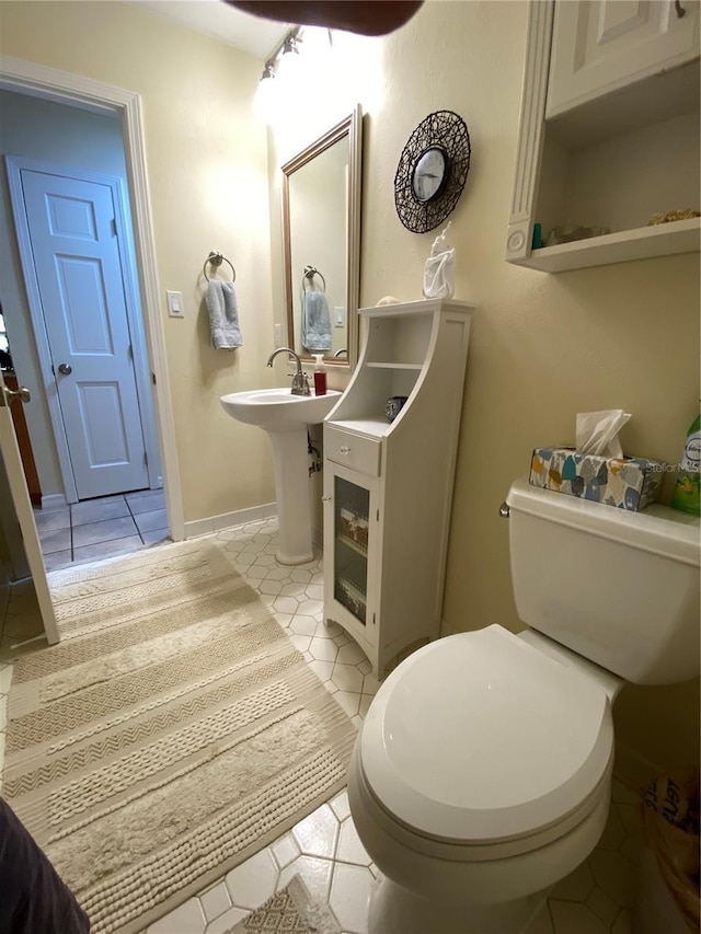 bathroom with toilet and tile patterned floors