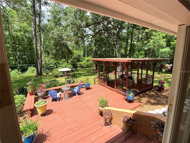 wooden deck featuring a lawn