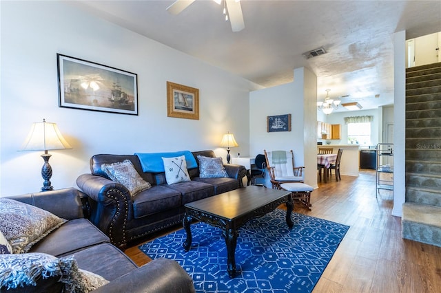 living room featuring ceiling fan and dark wood-type flooring