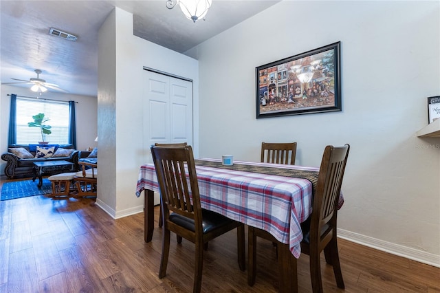 dining area featuring ceiling fan and dark hardwood / wood-style floors