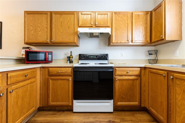 kitchen featuring white electric range oven, extractor fan, and dark wood-type flooring