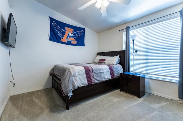 carpeted bedroom with vaulted ceiling and ceiling fan