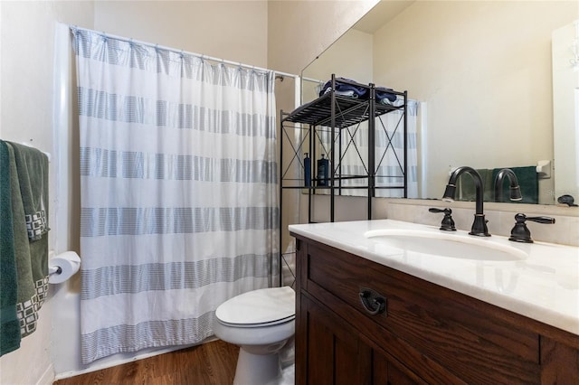 bathroom featuring hardwood / wood-style flooring, toilet, and large vanity