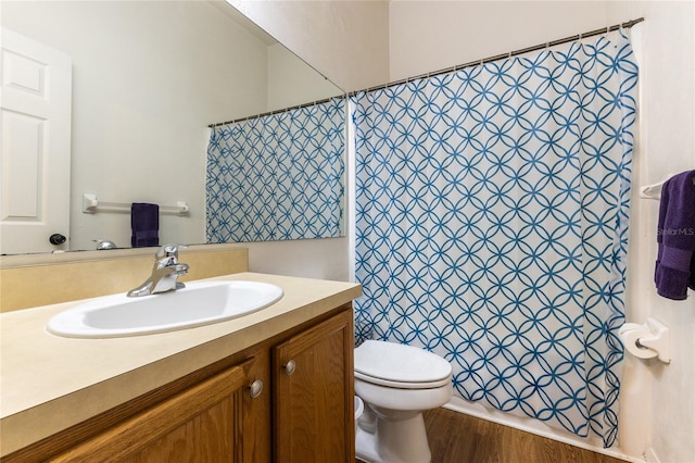 bathroom with oversized vanity, hardwood / wood-style floors, and toilet