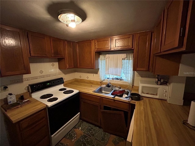 kitchen with tasteful backsplash, dark hardwood / wood-style floors, white appliances, and sink