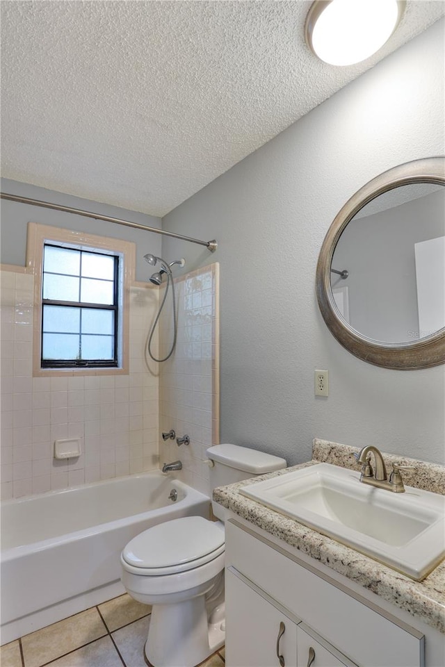 full bath featuring shower / bath combination, toilet, tile patterned flooring, a textured ceiling, and vanity