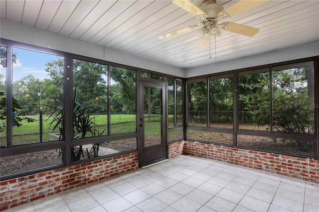 unfurnished sunroom with wooden ceiling and a ceiling fan