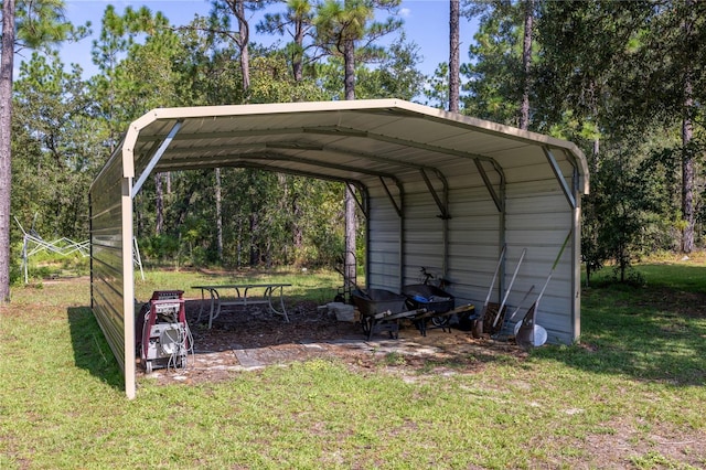 view of outdoor structure with a carport and a yard