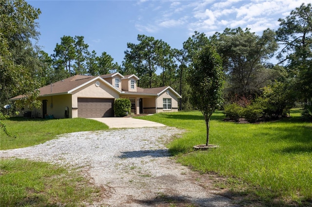 view of front of house with a front yard and a garage