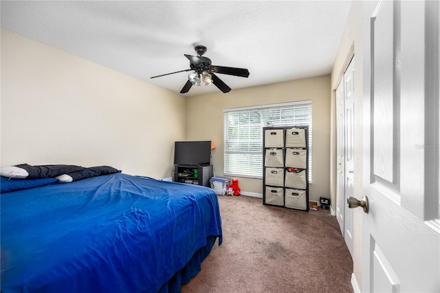 bedroom featuring carpet, ceiling fan, and a textured ceiling