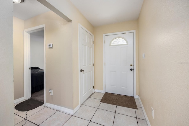 foyer entrance featuring light tile patterned floors