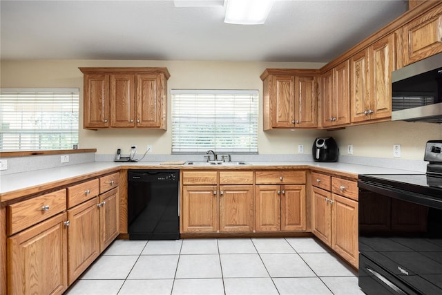 kitchen with light tile patterned flooring, sink, and black appliances