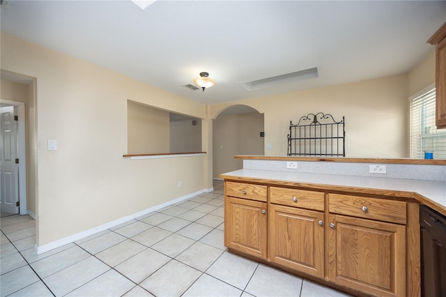 kitchen with black dishwasher and light tile patterned flooring