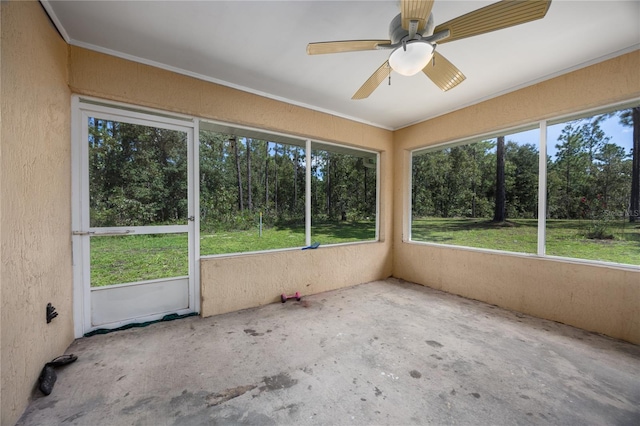 unfurnished sunroom featuring ceiling fan