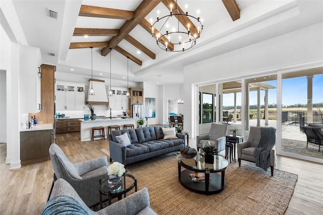 living room featuring beamed ceiling, light hardwood / wood-style floors, high vaulted ceiling, and a notable chandelier