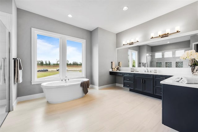 bathroom featuring vanity and a tub