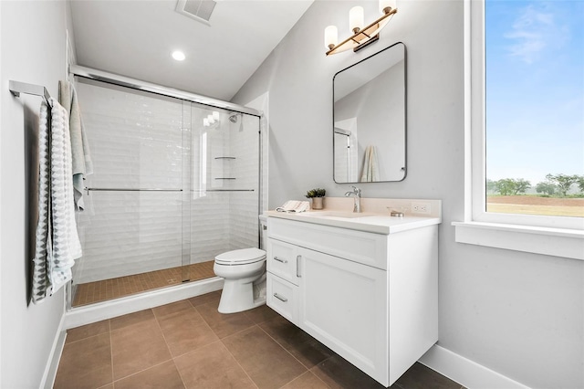 bathroom with walk in shower, large vanity, toilet, and tile floors