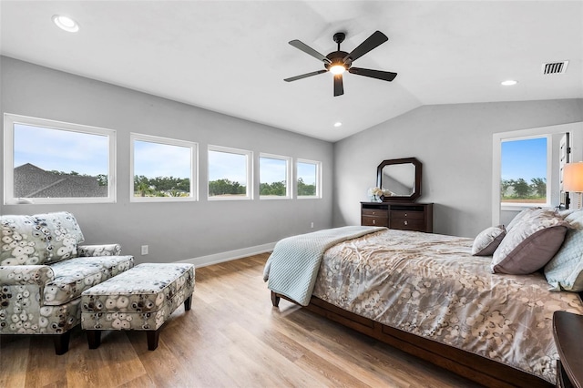 bedroom with ceiling fan, vaulted ceiling, and hardwood / wood-style flooring