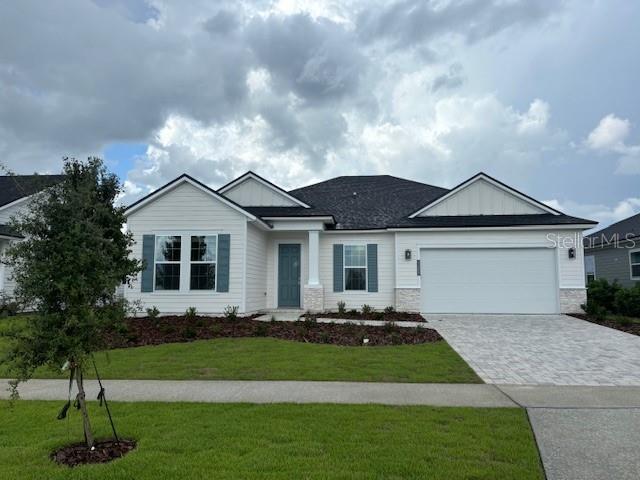 view of front of home with a garage and a front lawn