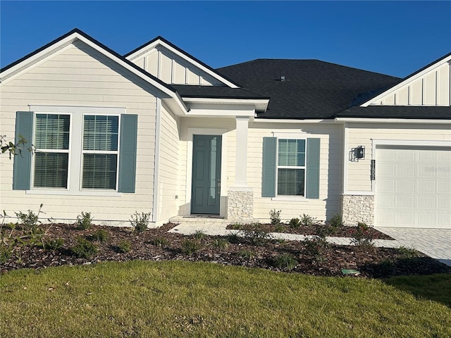 view of front of home with a front lawn and a garage