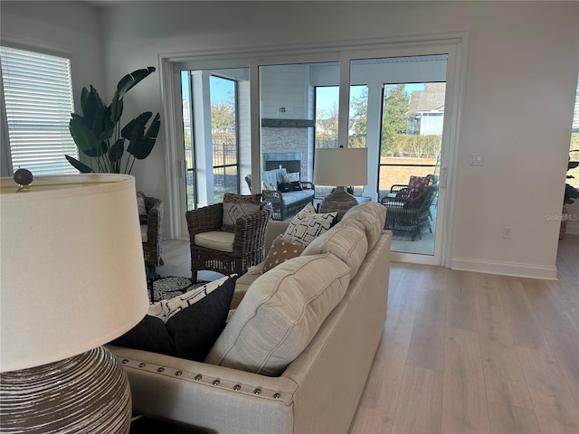 living room with a fireplace and light hardwood / wood-style floors