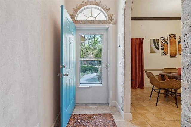 doorway to outside with light tile floors