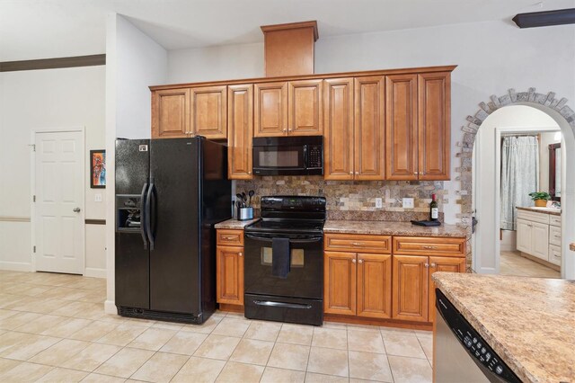 kitchen with tasteful backsplash, light tile floors, and black appliances