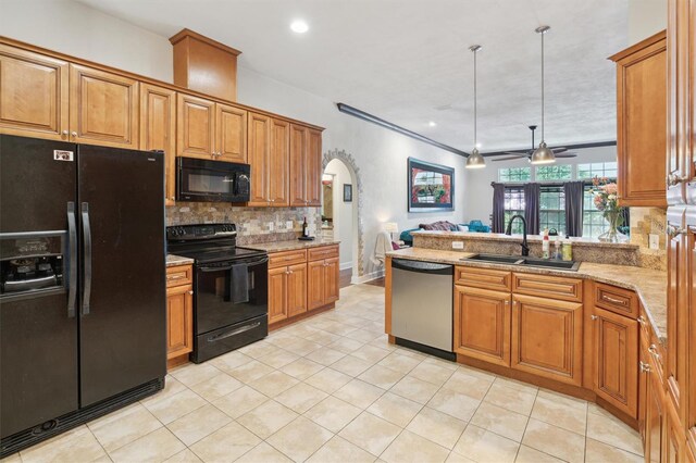 kitchen with ceiling fan, sink, tasteful backsplash, black appliances, and light stone countertops