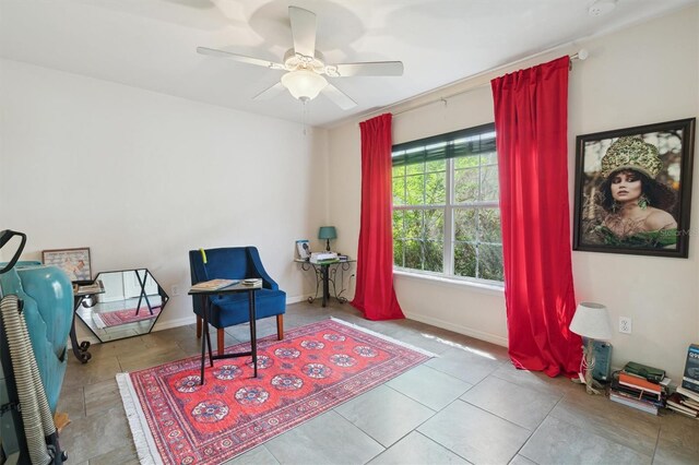 sitting room with tile flooring and ceiling fan