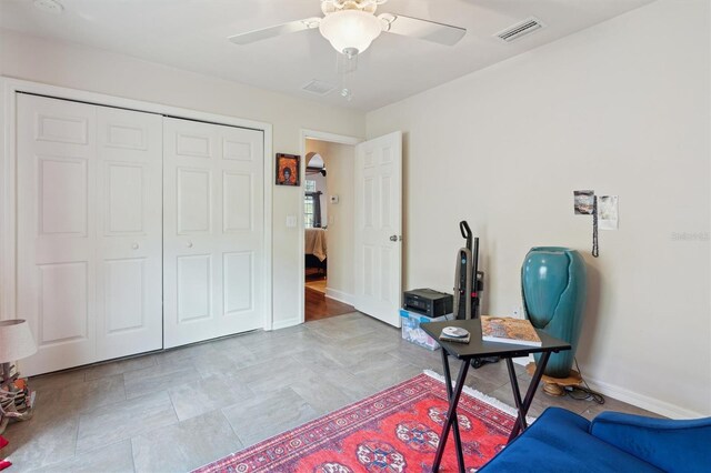 interior space with tile flooring and ceiling fan