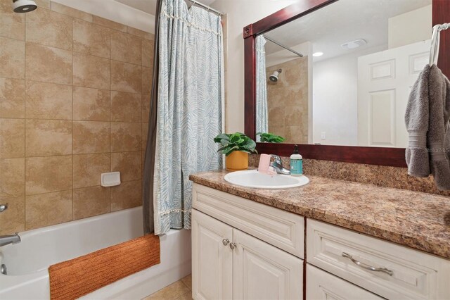 bathroom featuring oversized vanity and shower / tub combo with curtain