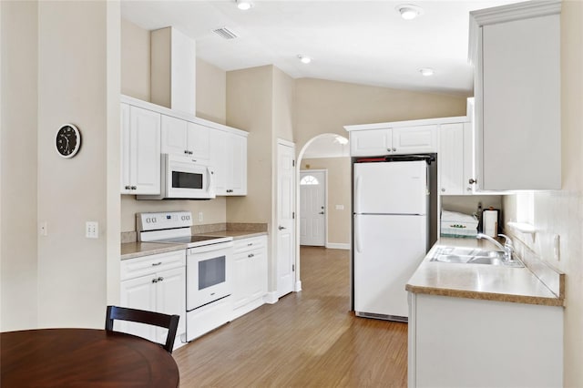 kitchen with sink, white cabinets, light hardwood / wood-style flooring, high vaulted ceiling, and white appliances