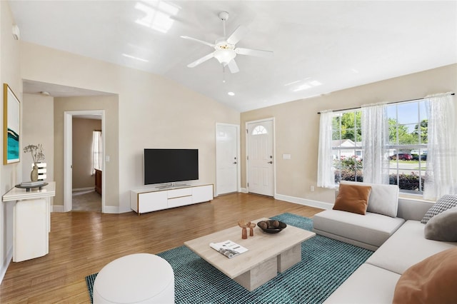 living room featuring vaulted ceiling, ceiling fan, and hardwood / wood-style flooring