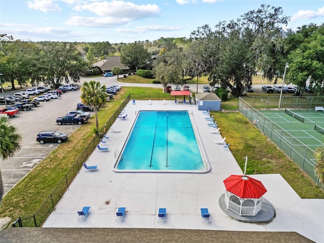 view of swimming pool with a patio area and a yard