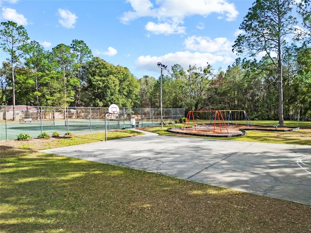 exterior space featuring a playground, basketball court, and a lawn