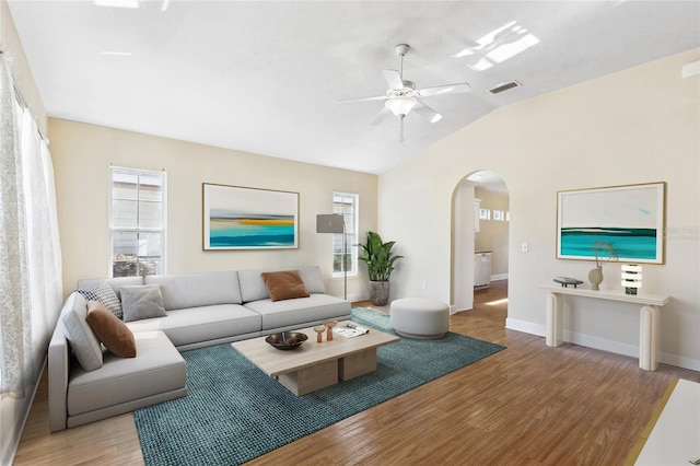 living room featuring ceiling fan, lofted ceiling, and light hardwood / wood-style flooring