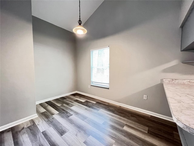 spare room with dark hardwood / wood-style floors and high vaulted ceiling