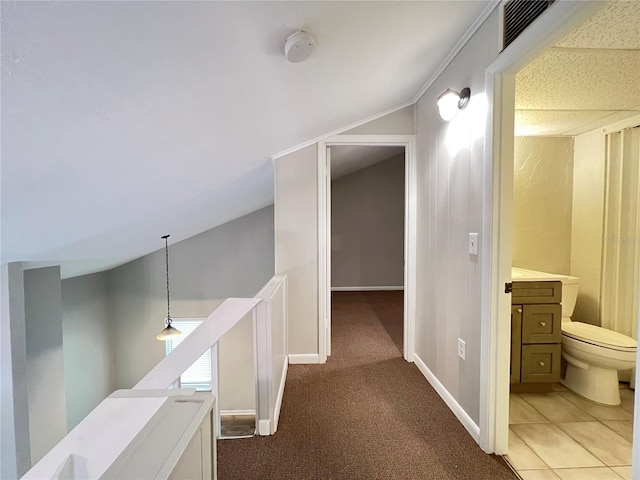 hallway with lofted ceiling, carpet flooring, and crown molding